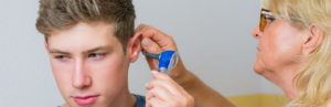 Teenager-receiving-a-check-up-on-his-ear