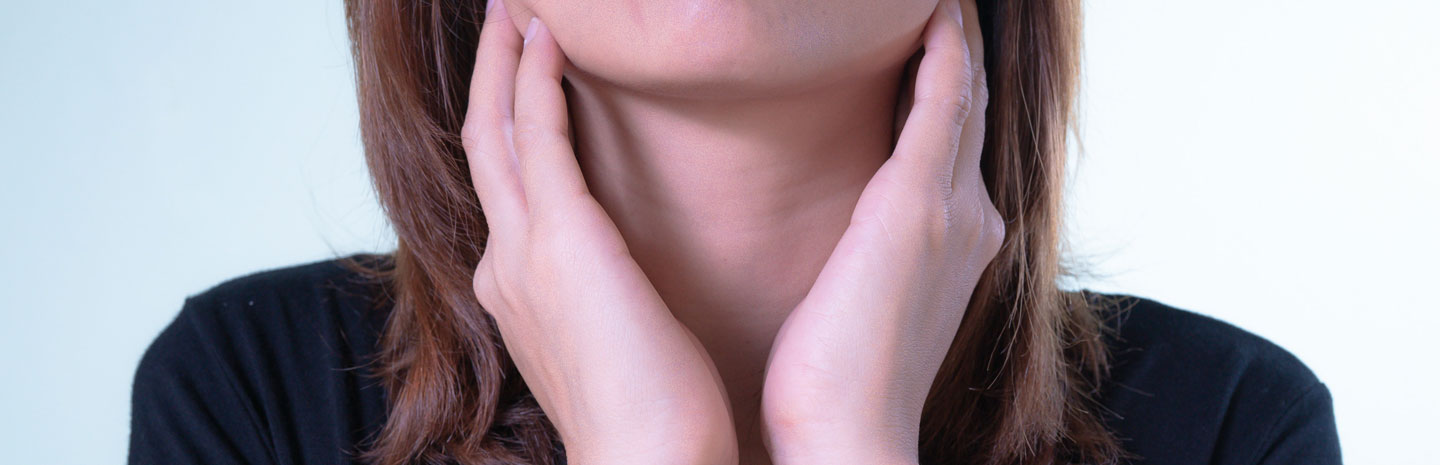 Woman grasping her throat from inflamed tonsils